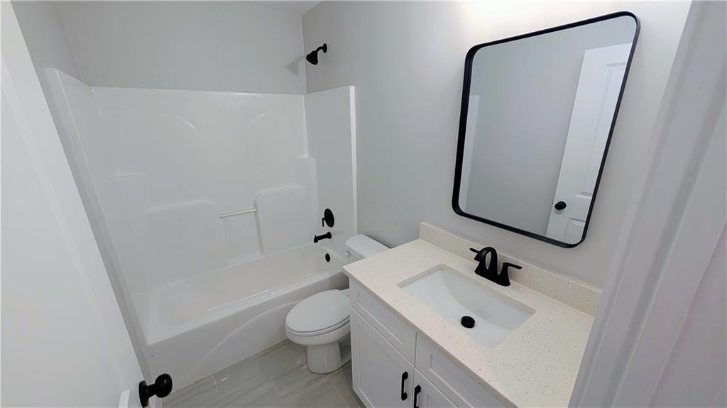 1706 Cunningham Road Southwest Marietta, GA 30008 - Photo 23 of 27 a bathroom with a toilet sink and mirror