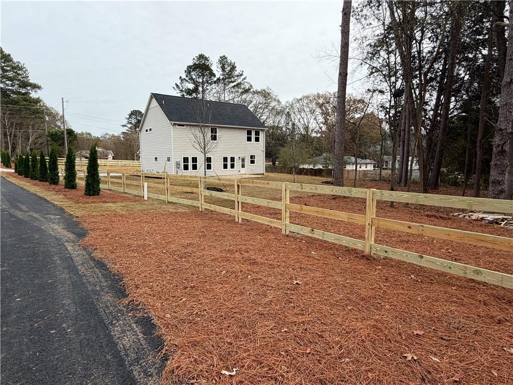 1706 Cunningham Road Southwest Marietta, GA 30008 - Photo 6 of 27 a view of a house with a yard and large trees