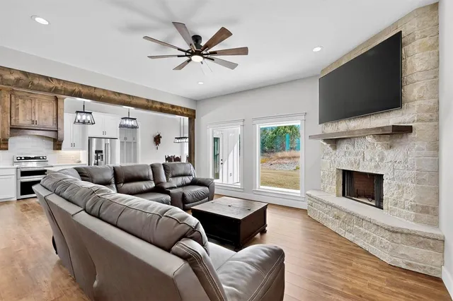 a living room with furniture a flat screen tv and a fireplace