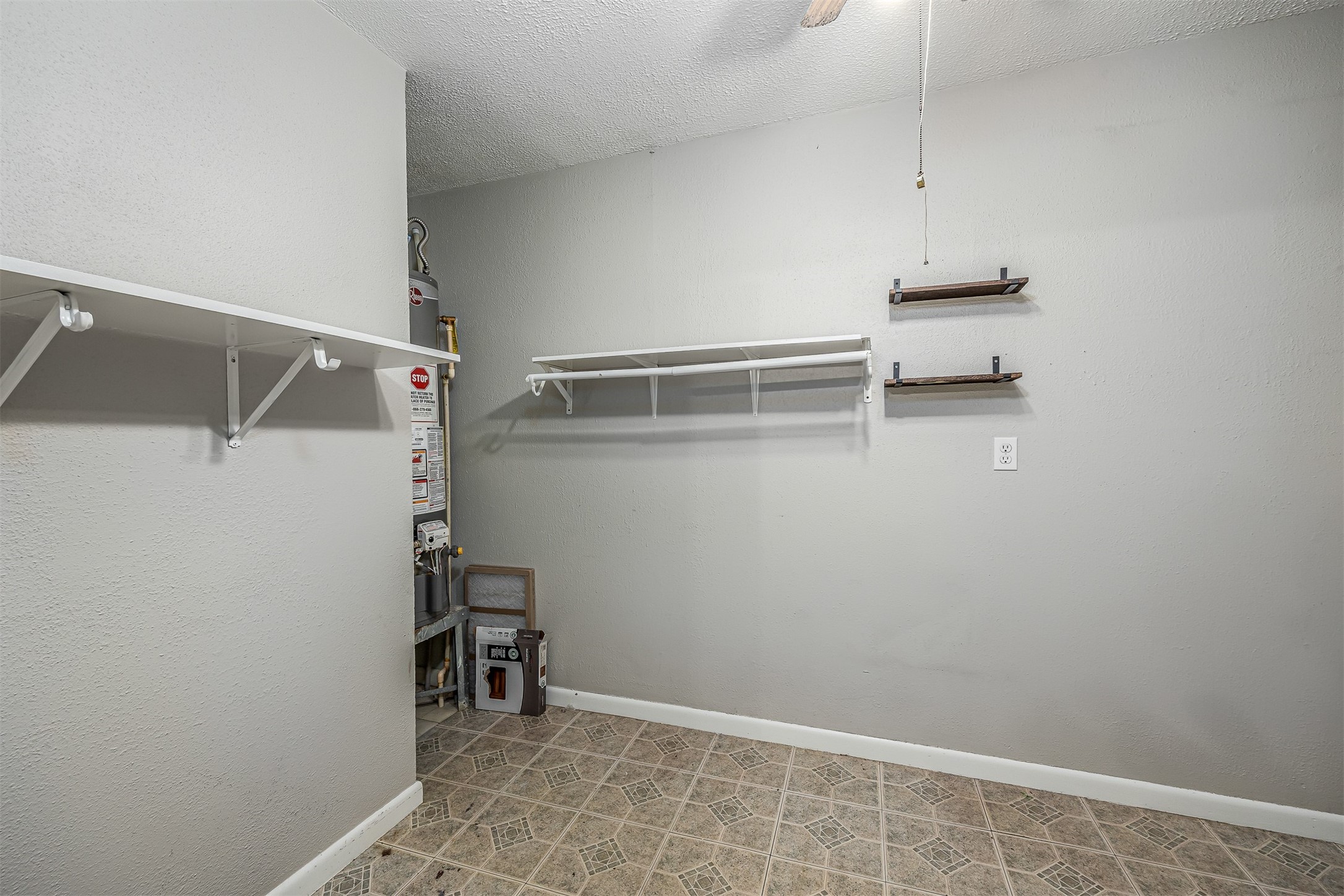 502 Massey Tompkins Road Baytown, TX 77521 - Photo 14 of 32 a view of storage and utility room with racks on the wall