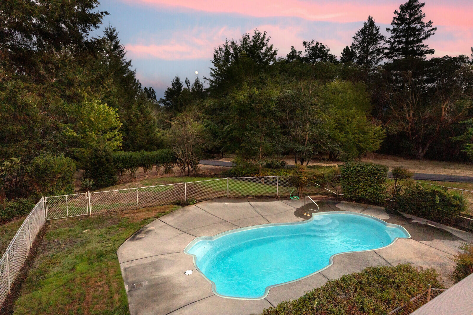 7212 Lower River Road Grants Pass, OR 97526 - Photo 16 of 31 a view of a swimming pool with a yard
