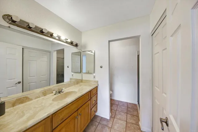 a bathroom with a granite countertop sink mirror and double