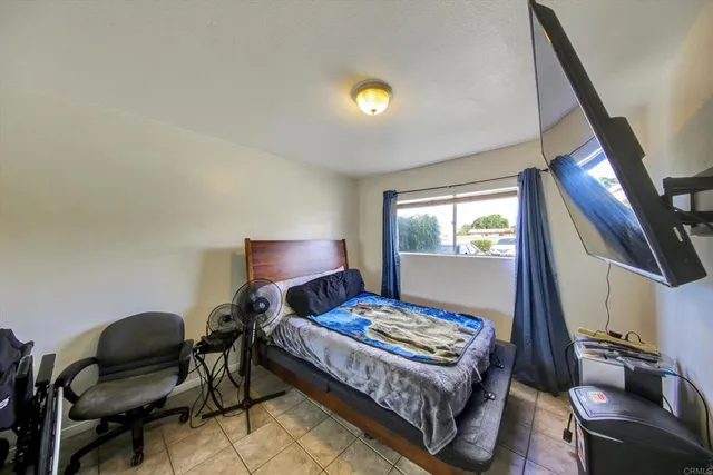 a bedroom with a bed and a chair