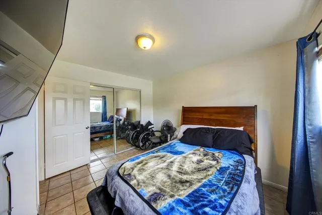 a bedroom with furniture and a wooden floor