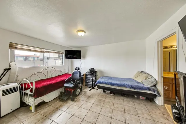 a bedroom with furniture and a flat screen tv