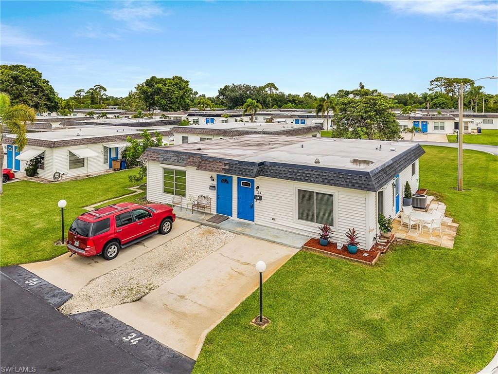 34 Hamlin Court Lehigh Acres, FL 33936 - Photo 24 of 29 a view of a house with backyard porch and sitting area