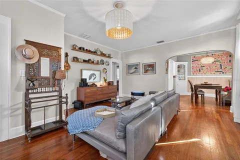 a living room with furniture and a chandelier