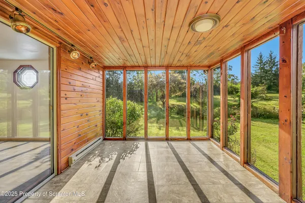 a view of balcony with wooden floor and fence