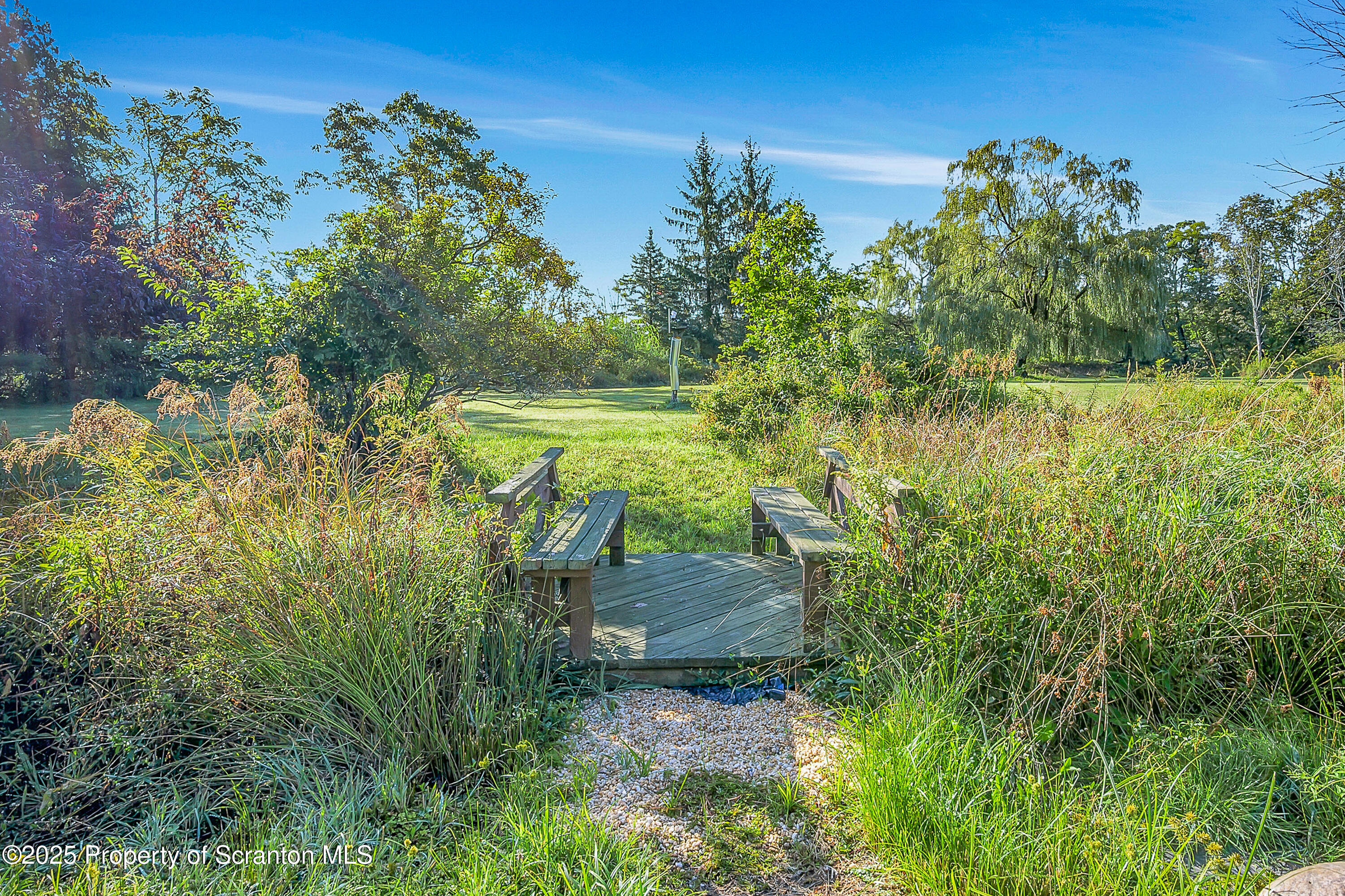 9119 Valley View Drive Clarks Summit, PA 18411 - Photo 73 of 78 a view of a lake with a building in front of it