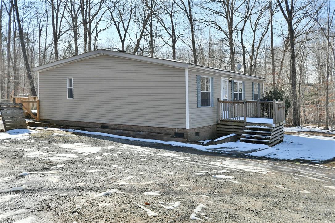 a view of a house with a yard covered in snow