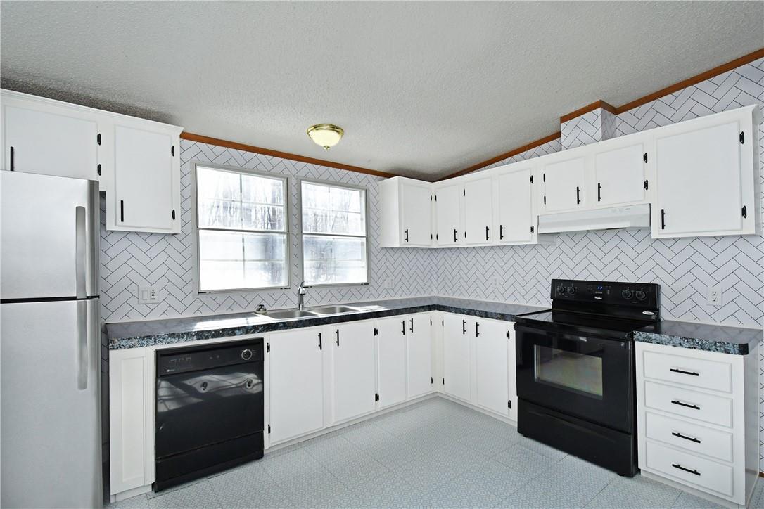 1524-l R L R Schronce Lane Iron Station, NC 28080 - Photo 7 of 32 a kitchen with white cabinets and white appliances