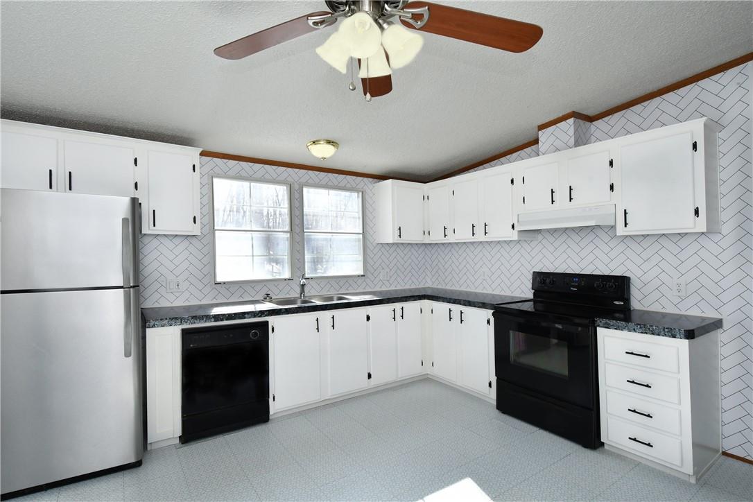 1524-l R L R Schronce Lane Iron Station, NC 28080 - Photo 8 of 32 a kitchen with granite countertop a sink a stove a refrigerator and white cabinets