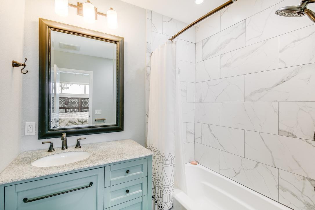 2015 Trumar Lane Gilroy, CA 95020 - Photo 14 of 30 a bathroom with a granite countertop sink mirror and a bathtub
