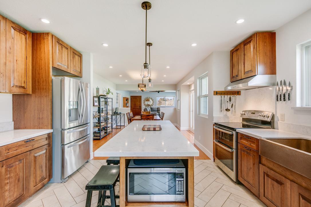 2015 Trumar Lane Gilroy, CA 95020 - Photo 10 of 30 a kitchen with stainless steel appliances a stove a sink a refrigerator white cabinets and wooden floor