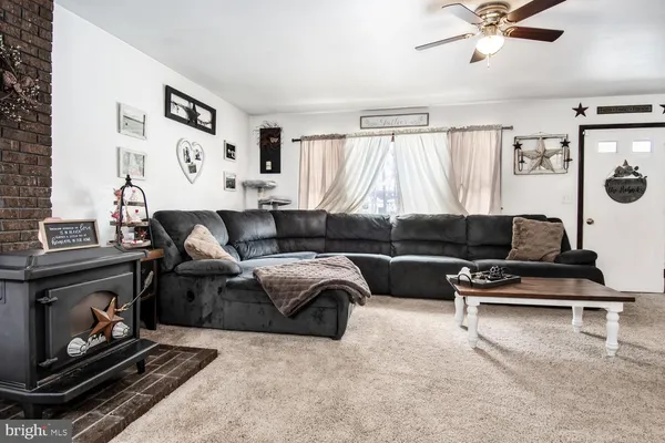 a living room with furniture and a fireplace
