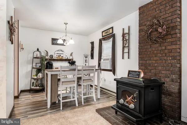 a kitchen with a stove and chairs