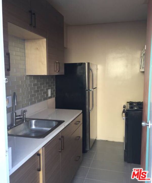 Undisclosed Address Norwalk, CA 90650 - Photo 16 of 19 a kitchen with a sink and refrigerator