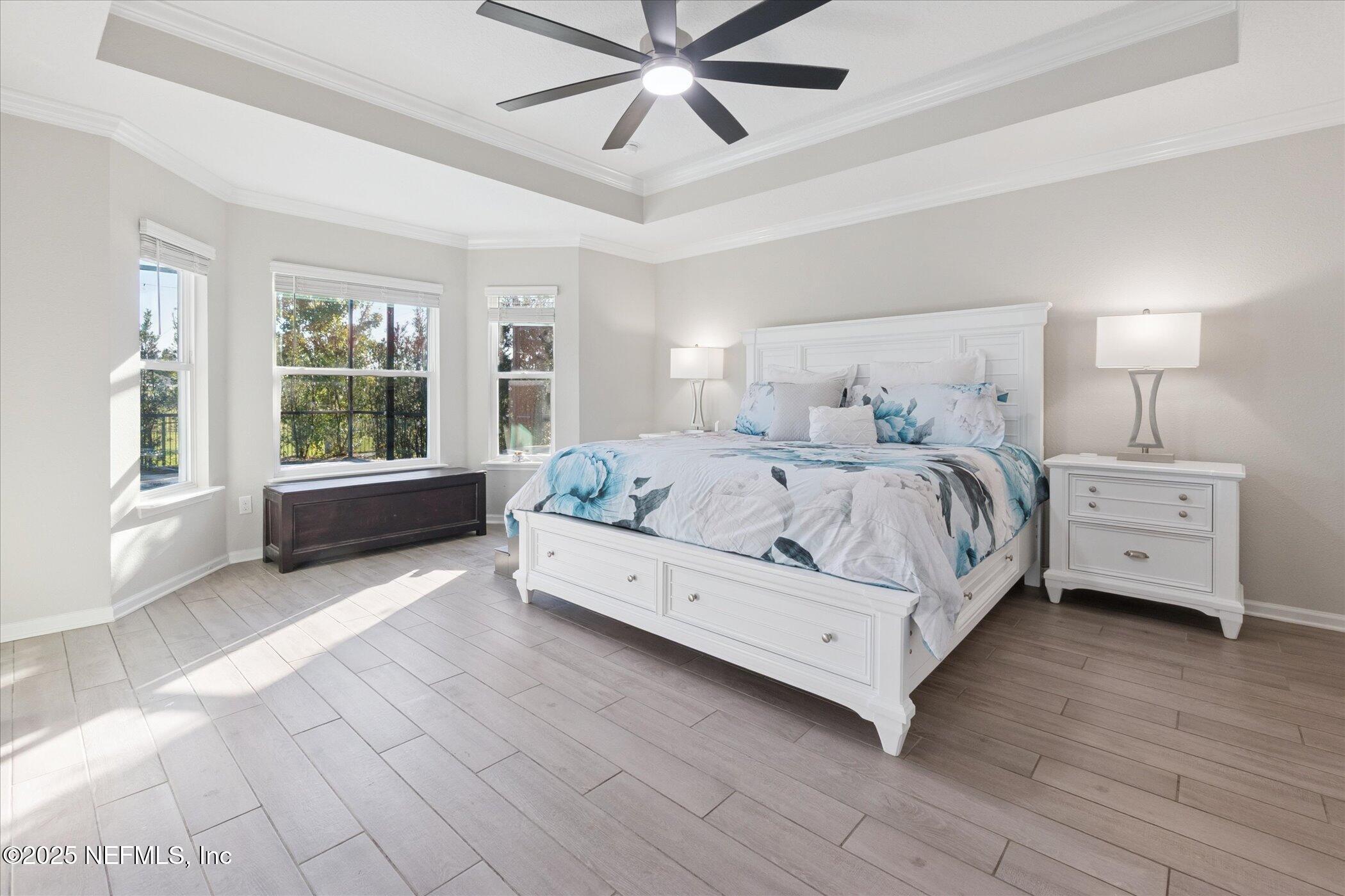 49 Sunberry Way St. Augustine, FL 32092 - Photo 12 of 30 a bedroom with a bed and a large window with wooden floor