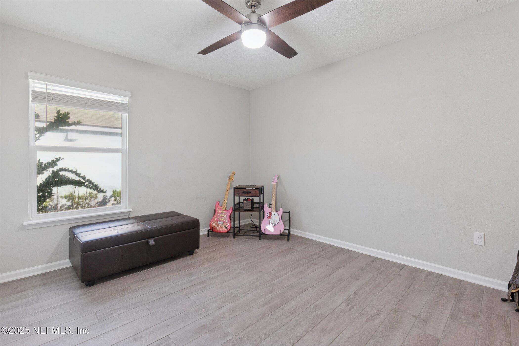 49 Sunberry Way St. Augustine, FL 32092 - Photo 17 of 30 a living room with a bed furniture and a window