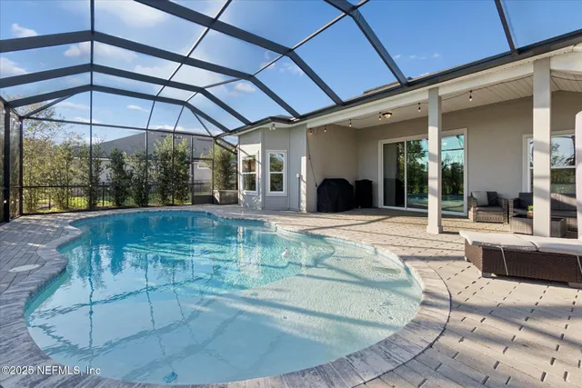 a view of a swimming pool with sitting area