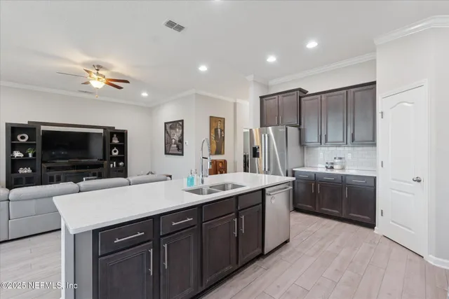 a kitchen with a sink appliances and cabinets