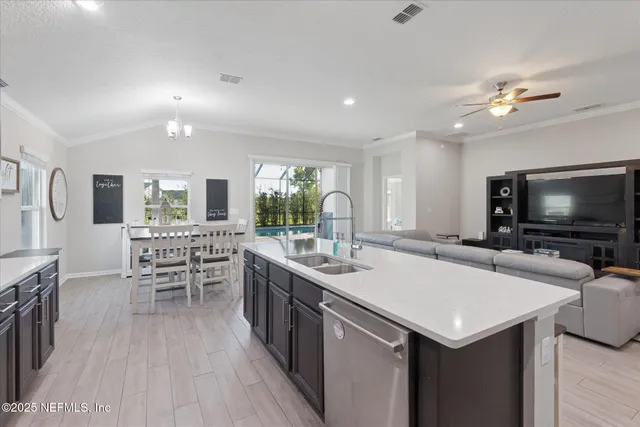 a room with furniture a flat screen tv and a chandelier