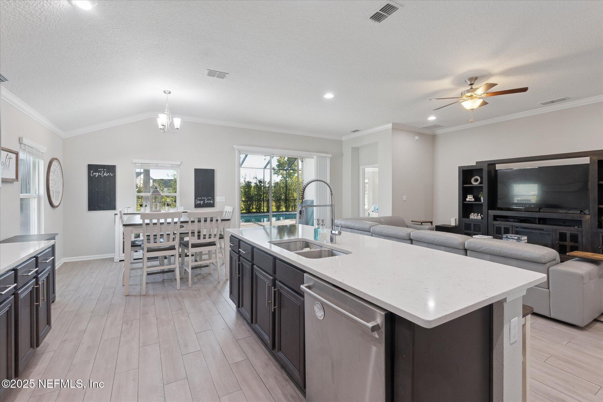 49 Sunberry Way St. Augustine, FL 32092 - Photo 9 of 30 a room with furniture a flat screen tv and a chandelier