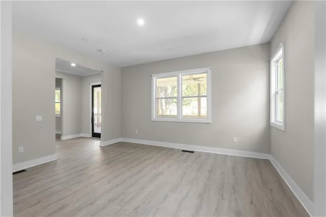 a large kitchen with stainless steel appliances lots of counter space and wooden floor