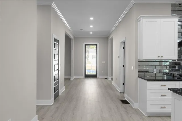 a kitchen with stainless steel appliances kitchen island granite countertop a stove a sink and a microwave