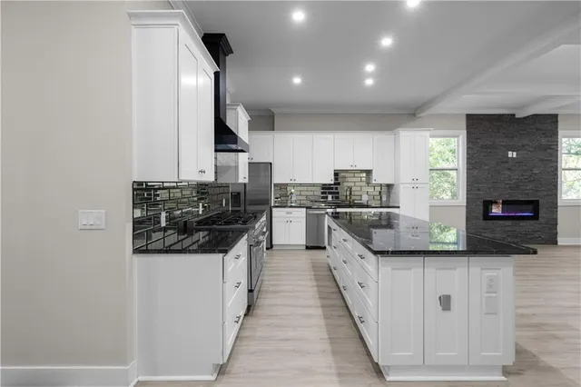 a spacious bathroom with a double vanity sink a large mirror and a shower