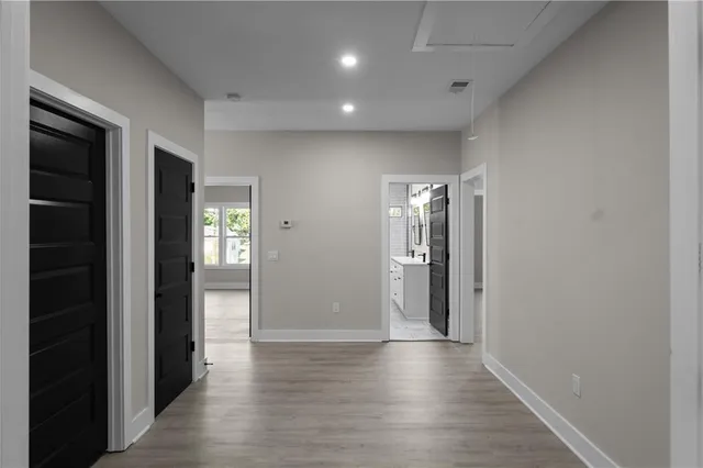 a spacious bathroom with a double vanity sink a mirror and a bathtub