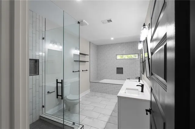 a bathroom with a glass shower door