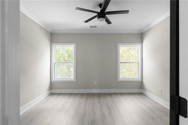 a view of walk in closet with empty racks