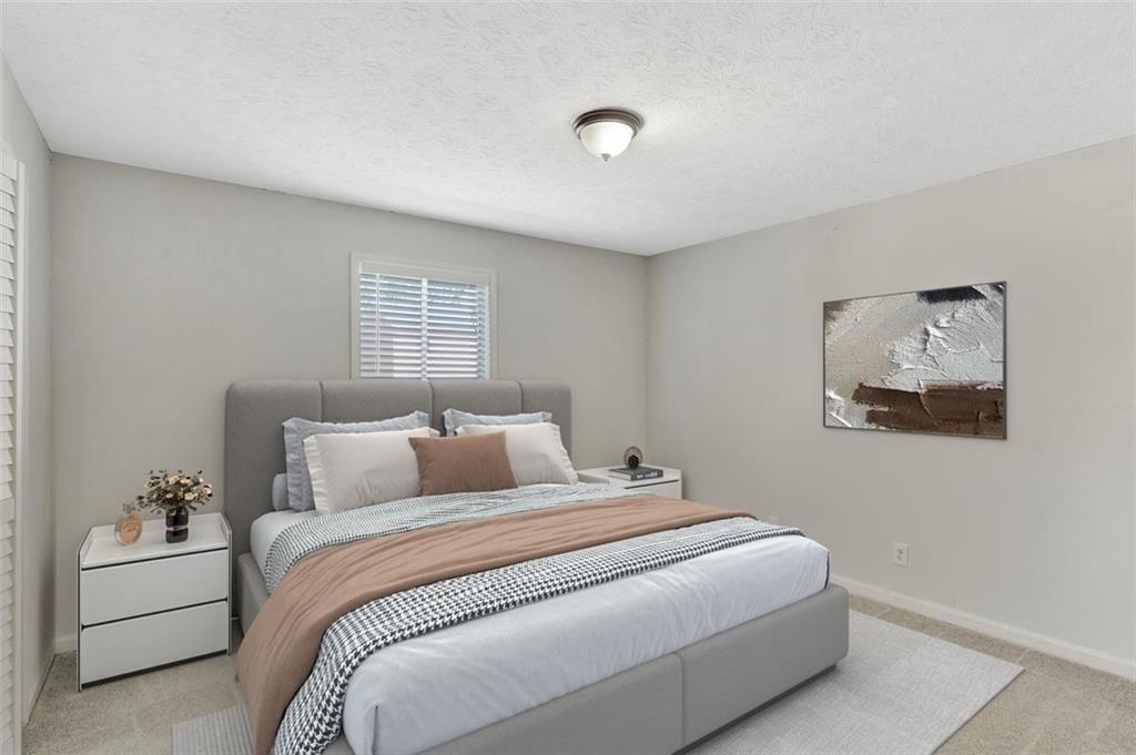 2390 Lawrenceville Highway, Unit K Decatur, GA 30033 - Photo 14 of 22 a bedroom with a large bed and a couch