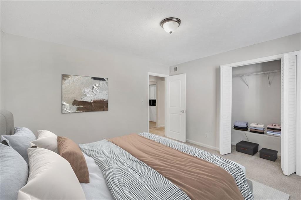 2390 Lawrenceville Highway, Unit K Decatur, GA 30033 - Photo 15 of 22 a bedroom with a bed and walk in closet