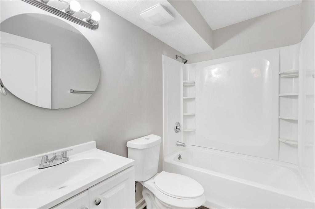 2390 Lawrenceville Highway, Unit K Decatur, GA 30033 - Photo 17 of 22 a bathroom with a sink a toilet and shower