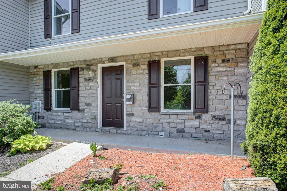 604 Fairview Avenue Waynesboro, PA 17268 - Photo 3 of 30 Charming stone facade with lush greenery.