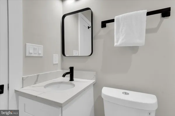 a bathroom with a toilet sink and mirror