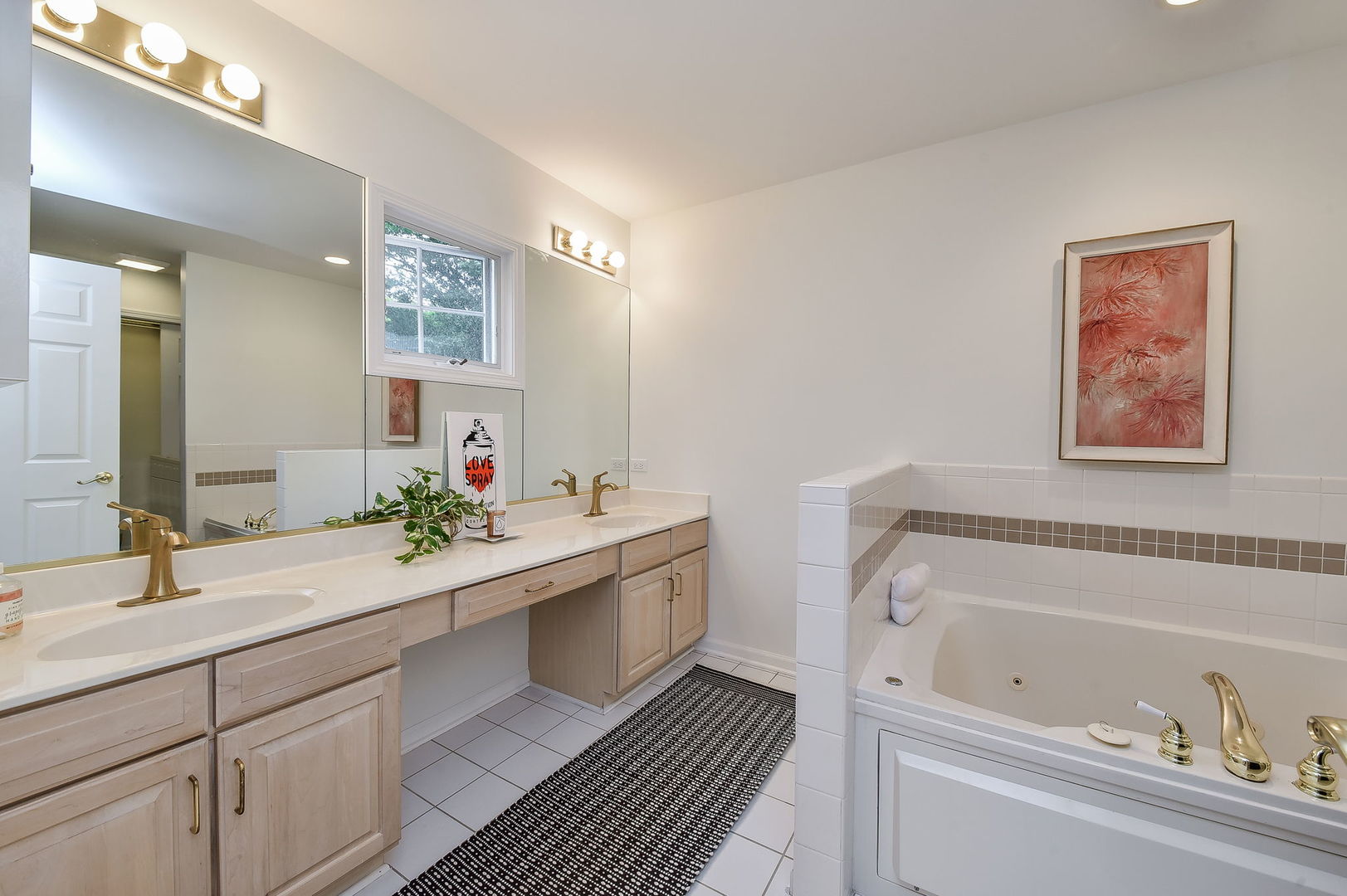 704 Natwill Square Geneva, IL 60134 - Photo 16 of 35 a bathroom with a tub sink and mirror
