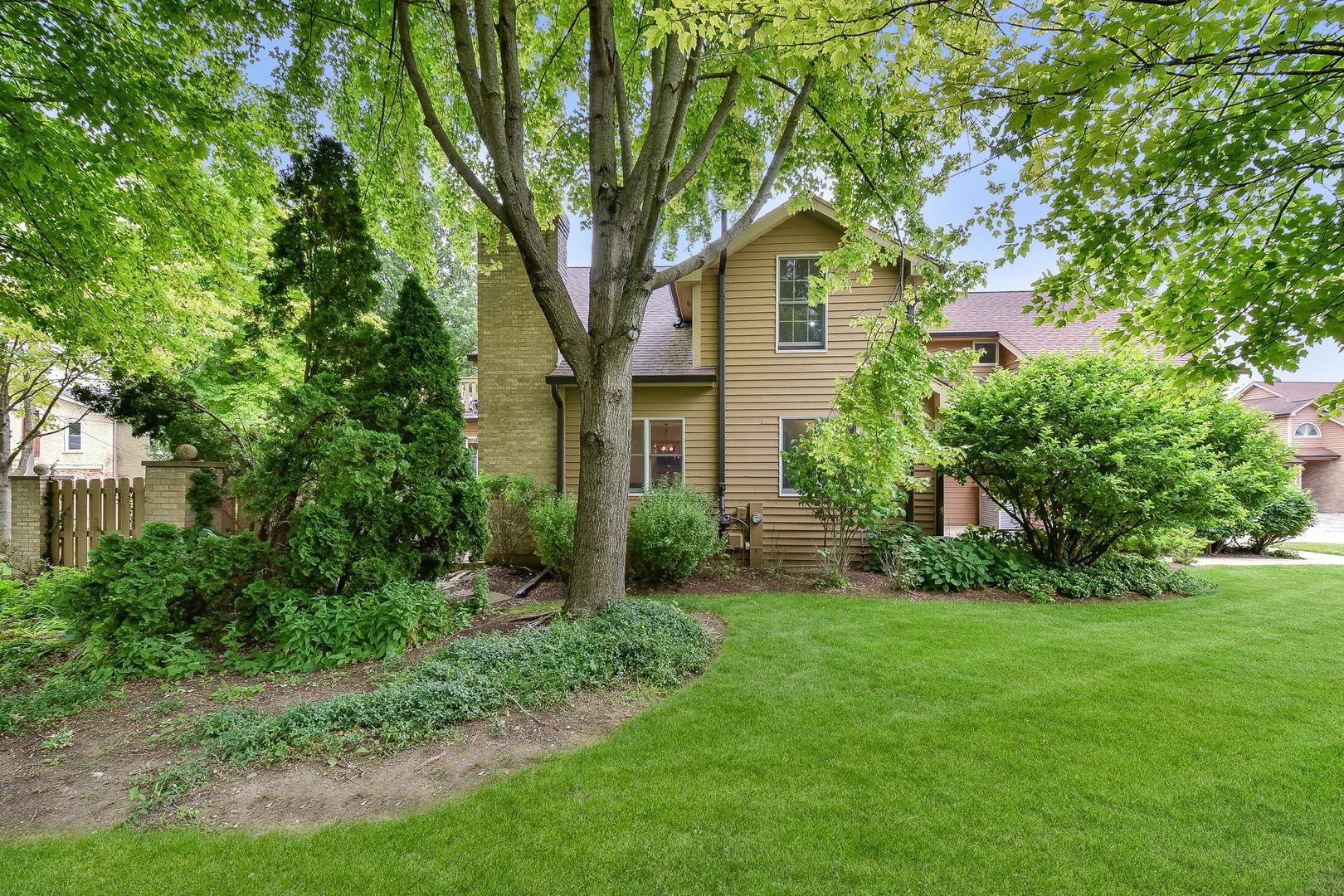 704 Natwill Square Geneva, IL 60134 - Photo 28 of 35 a front view of a house with a yard and trees