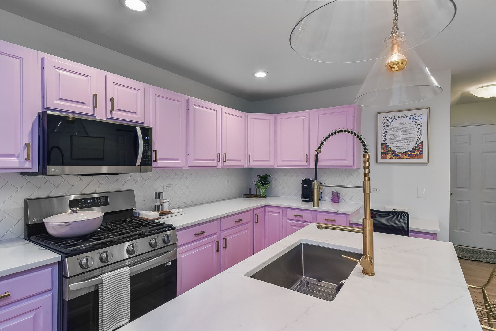 704 Natwill Square Geneva, IL 60134 - Photo 8 of 35 a kitchen with kitchen island granite countertop a sink a stove top oven and cabinetry