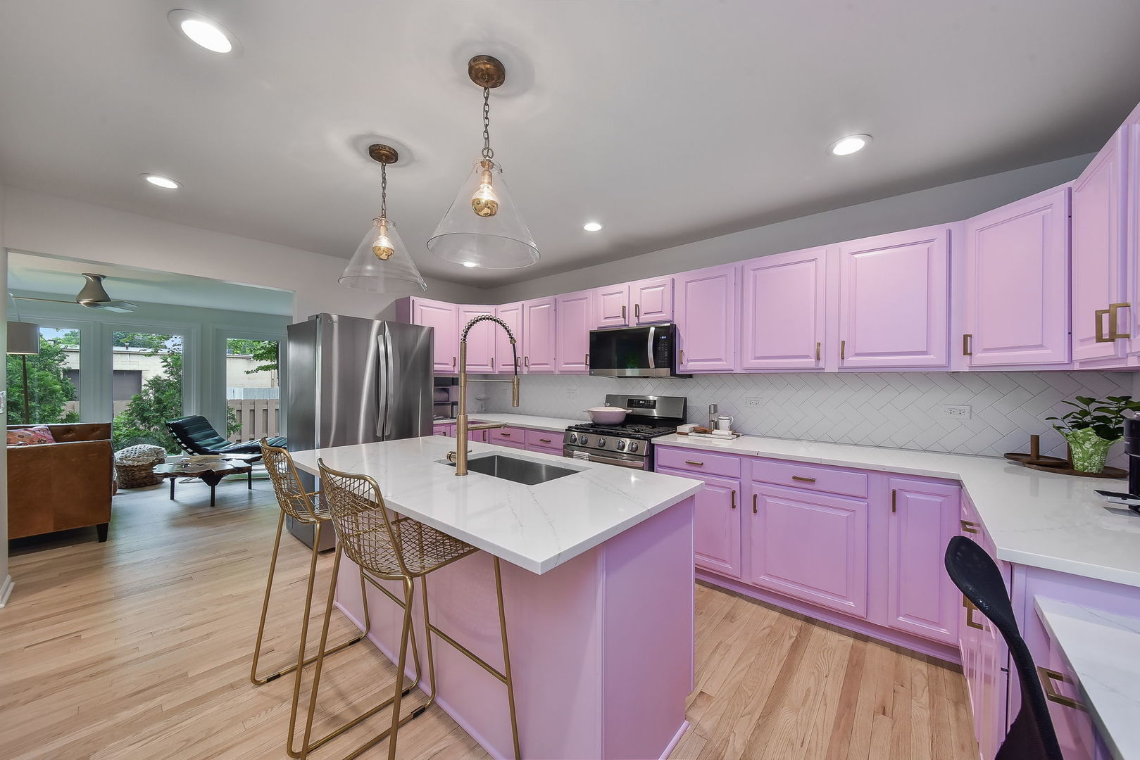 704 Natwill Square Geneva, IL 60134 - Photo 9 of 35 a kitchen with a stove a refrigerator a sink dishwasher with a dining table and chairs with wooden floor