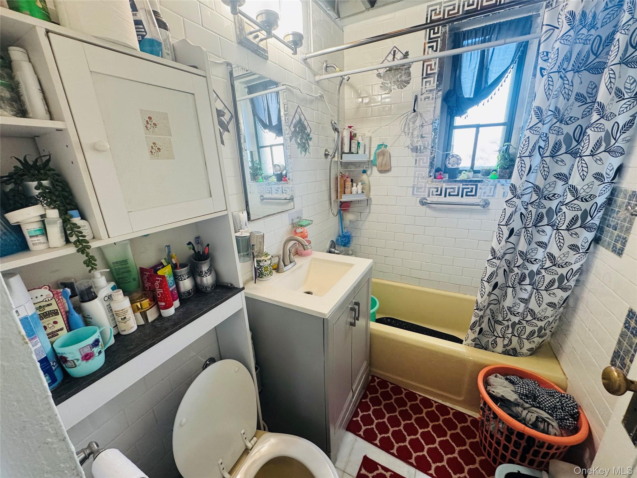 18 Metropolitan Ovl, Unit 8A Bronx, NY 10462 - Photo 5 of 5 a bathroom with a toilet a sink and a shower