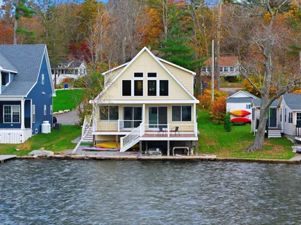 a aerial view of a house with a yard and large trees