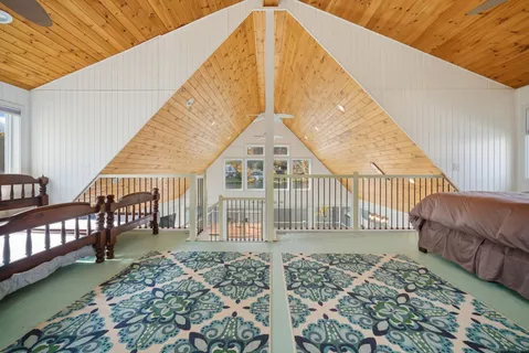 a view of a house with a wooden deck