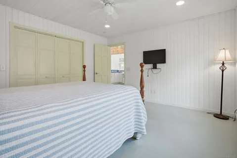 a bedroom with a bed and a flat screen tv