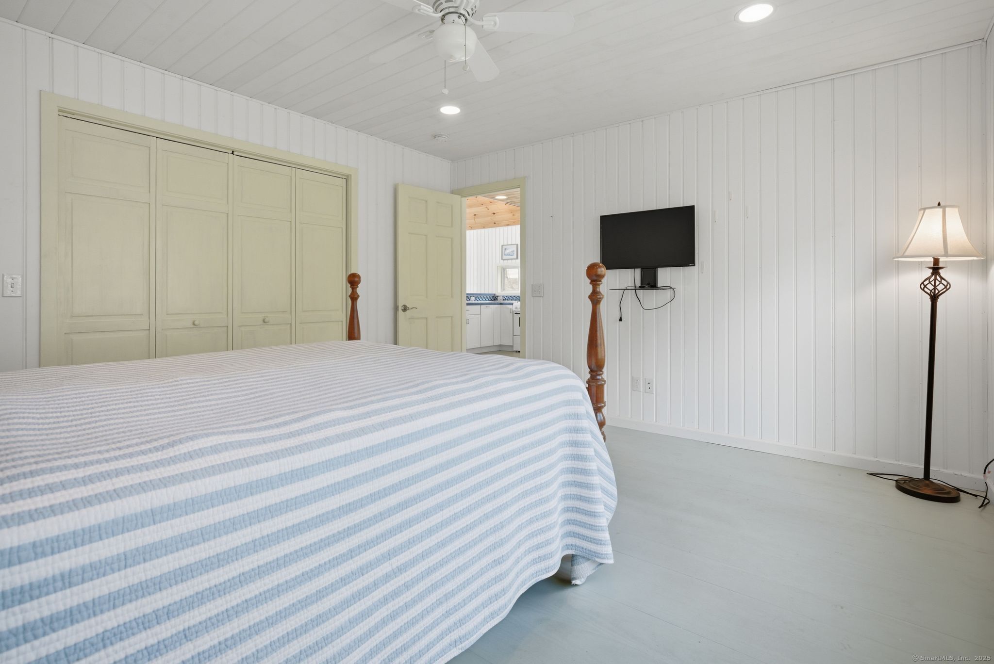 136 Sandy Beach Road Goshen, CT 06756 - Photo 18 of 26 a bedroom with a bed and a flat screen tv