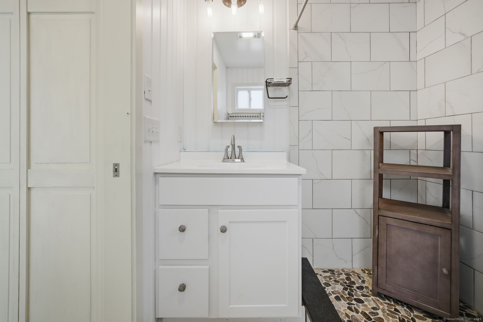136 Sandy Beach Road Goshen, CT 06756 - Photo 21 of 26 a bathroom with a sink and a mirror