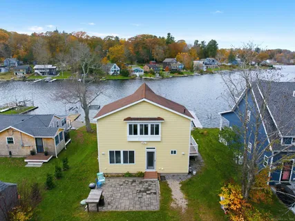 an aerial view of a house with garden space and a large tree