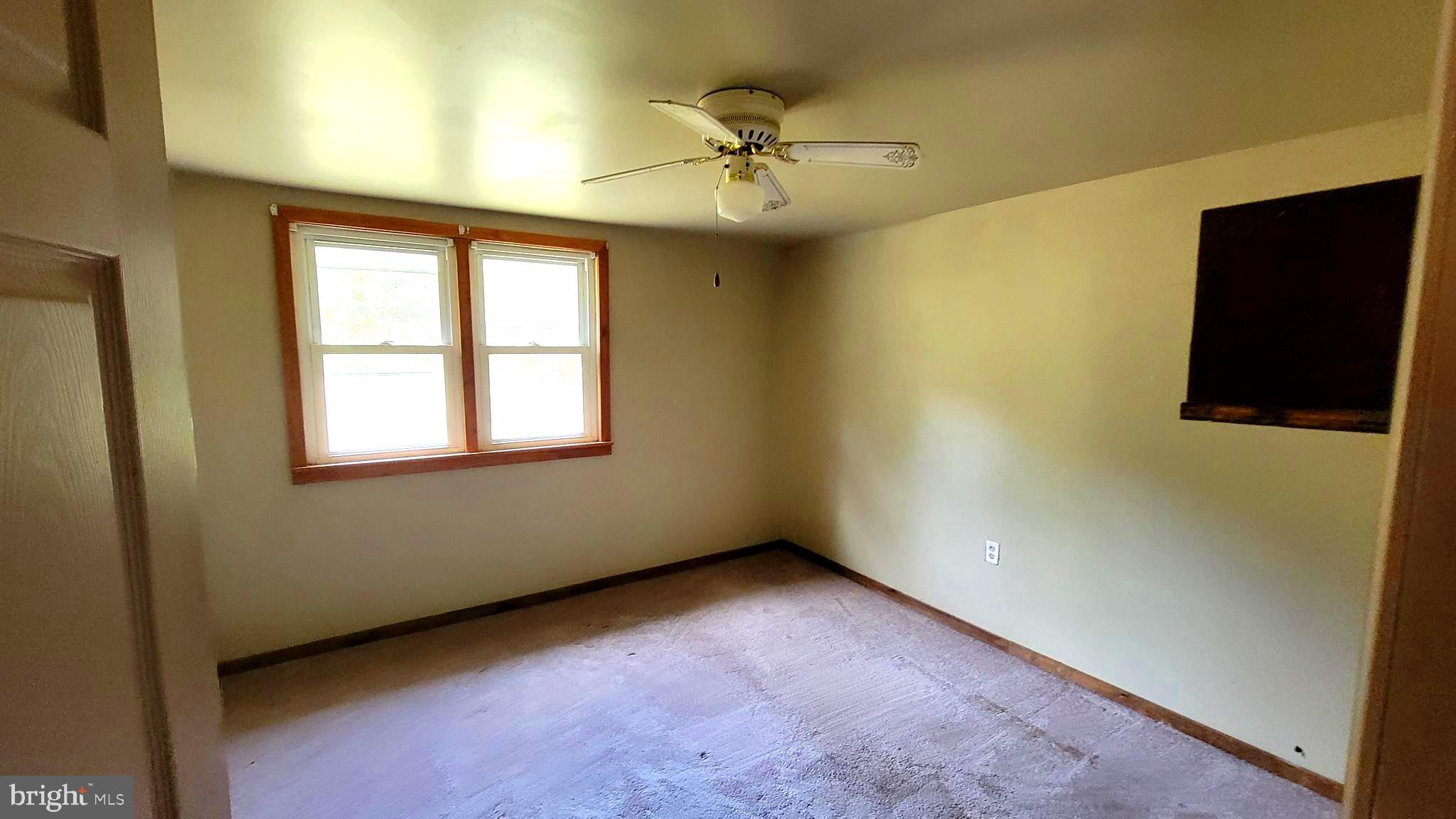 12809 Walsh Road Mount Savage, MD 21545 - Photo 28 of 30 an empty room with a ceiling fan and a window
